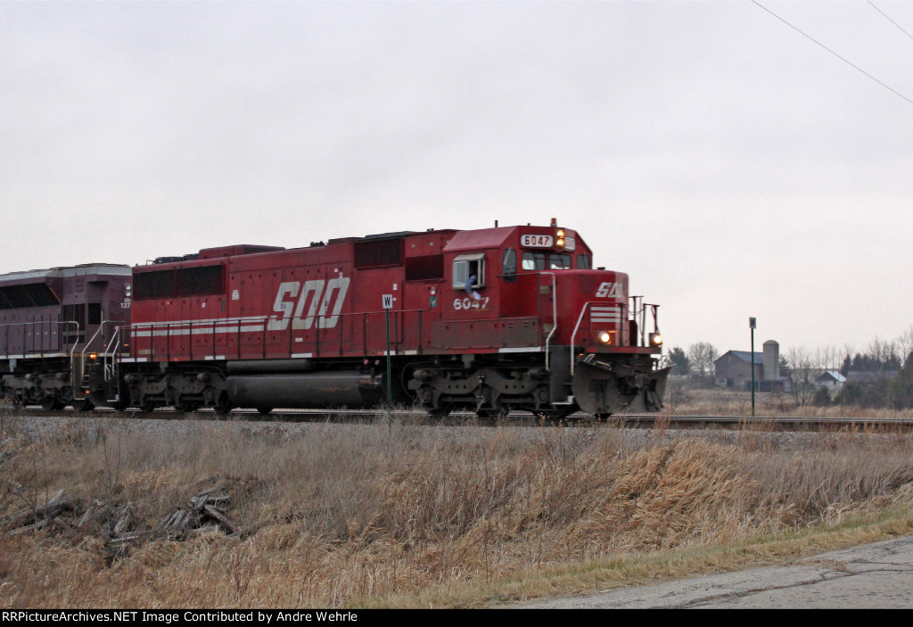 SOO 6047 highballs towards Frank Rd. with EB coal loads train 804